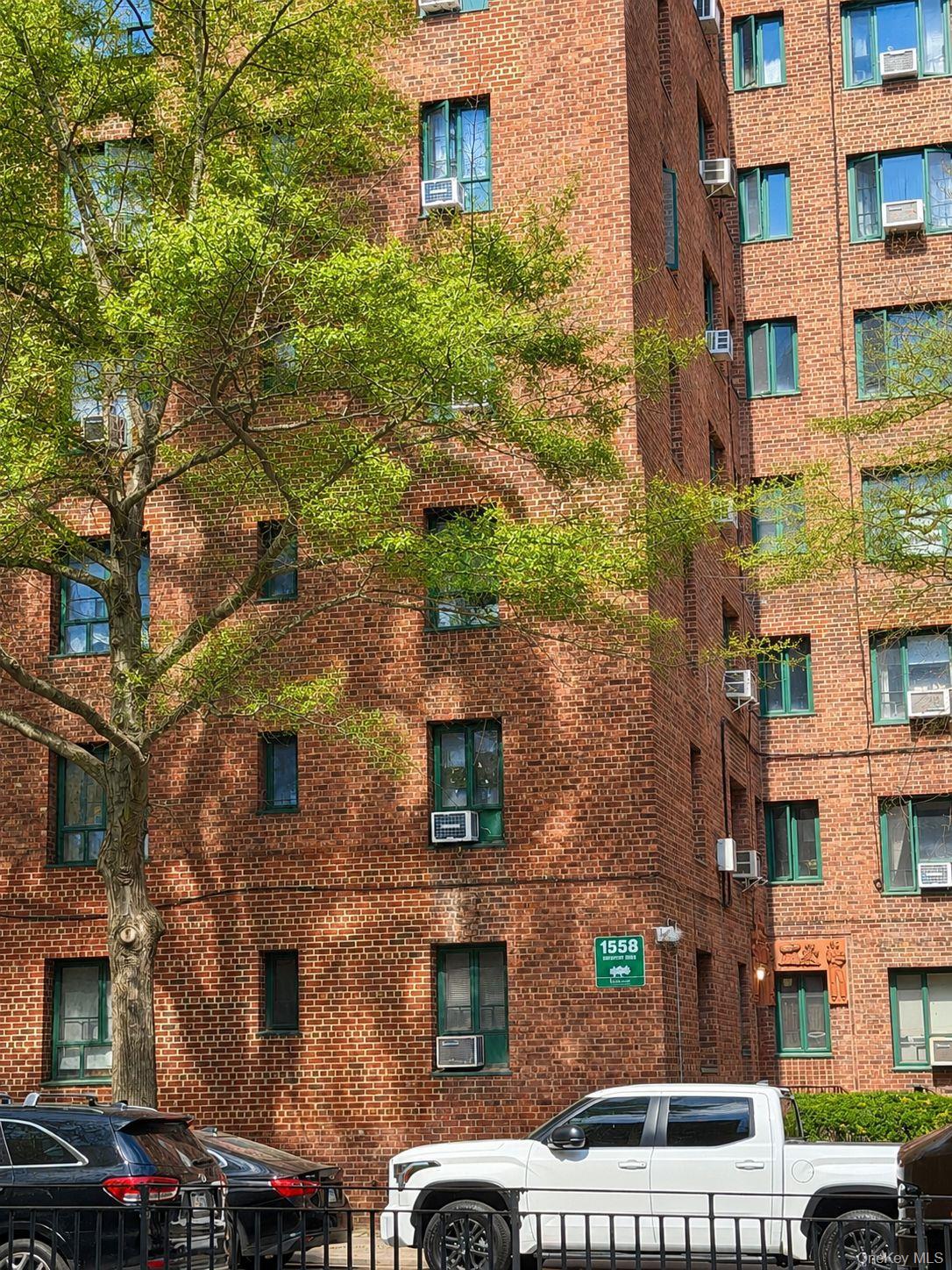 1558 Unionport Road, Unit 2D Bronx, NY 10462 - Photo 9 of 9 a front view of a building with a yard