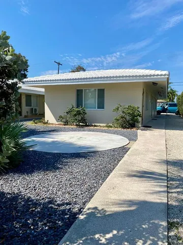a front view of house with yard and outdoor seating