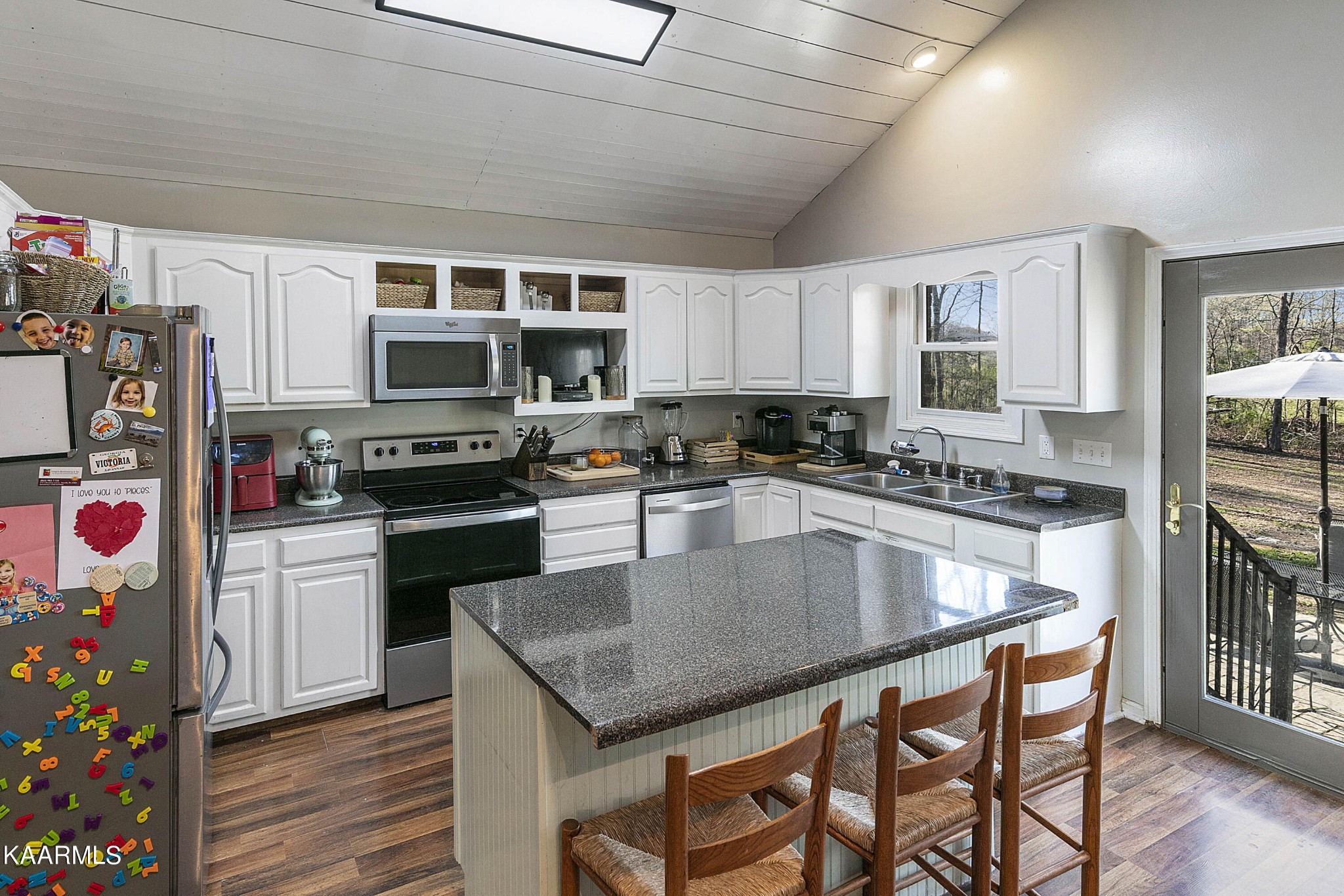 1434 Cunningham Road West Seymour, TN 37865 - Photo 13 of 31 a kitchen with stainless steel appliances granite countertop a stove a sink dishwasher a microwave oven with a dining table and chairs