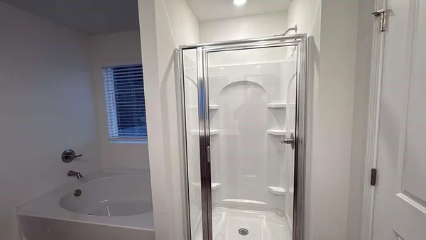 a bathroom with a glass shower door