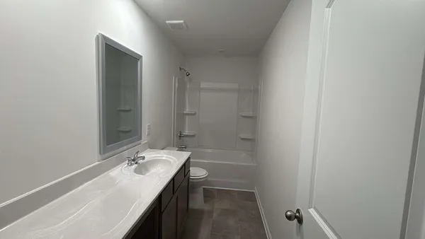 a bathroom with a sink a mirror and a shower