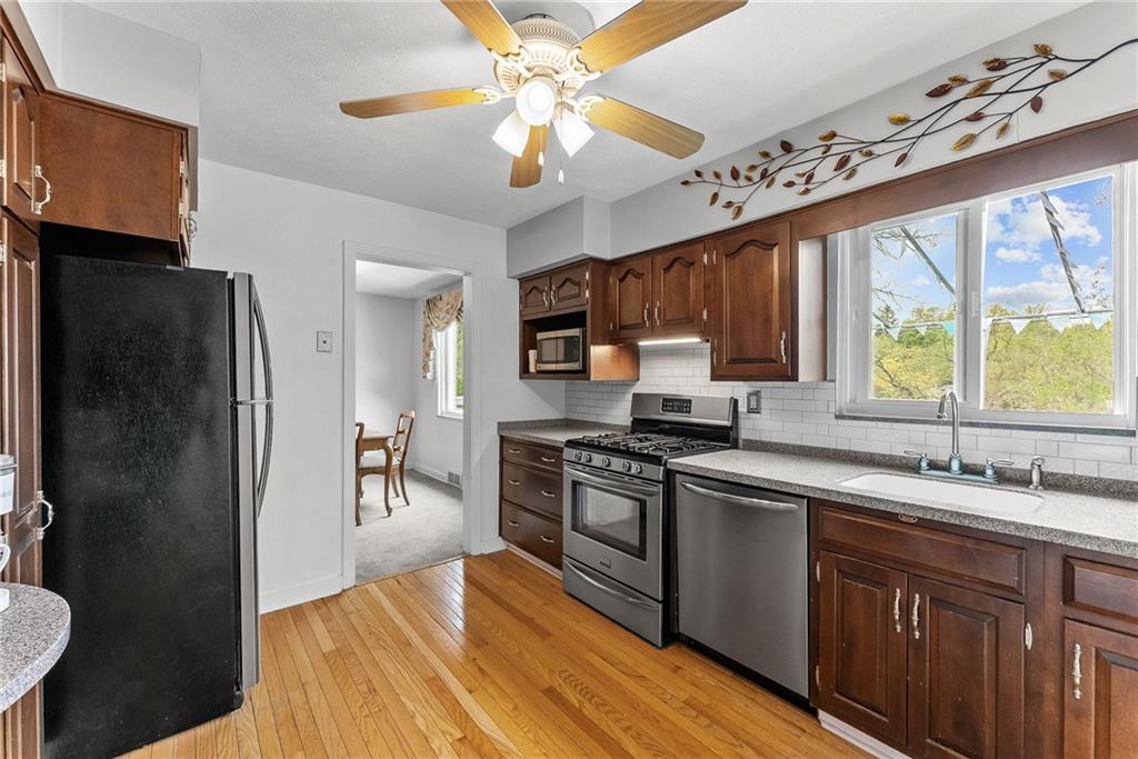 466 Haverhill Road Pittsburgh, PA 15228 - Photo 9 of 41 a kitchen with stainless steel appliances granite countertop a sink stove and refrigerator