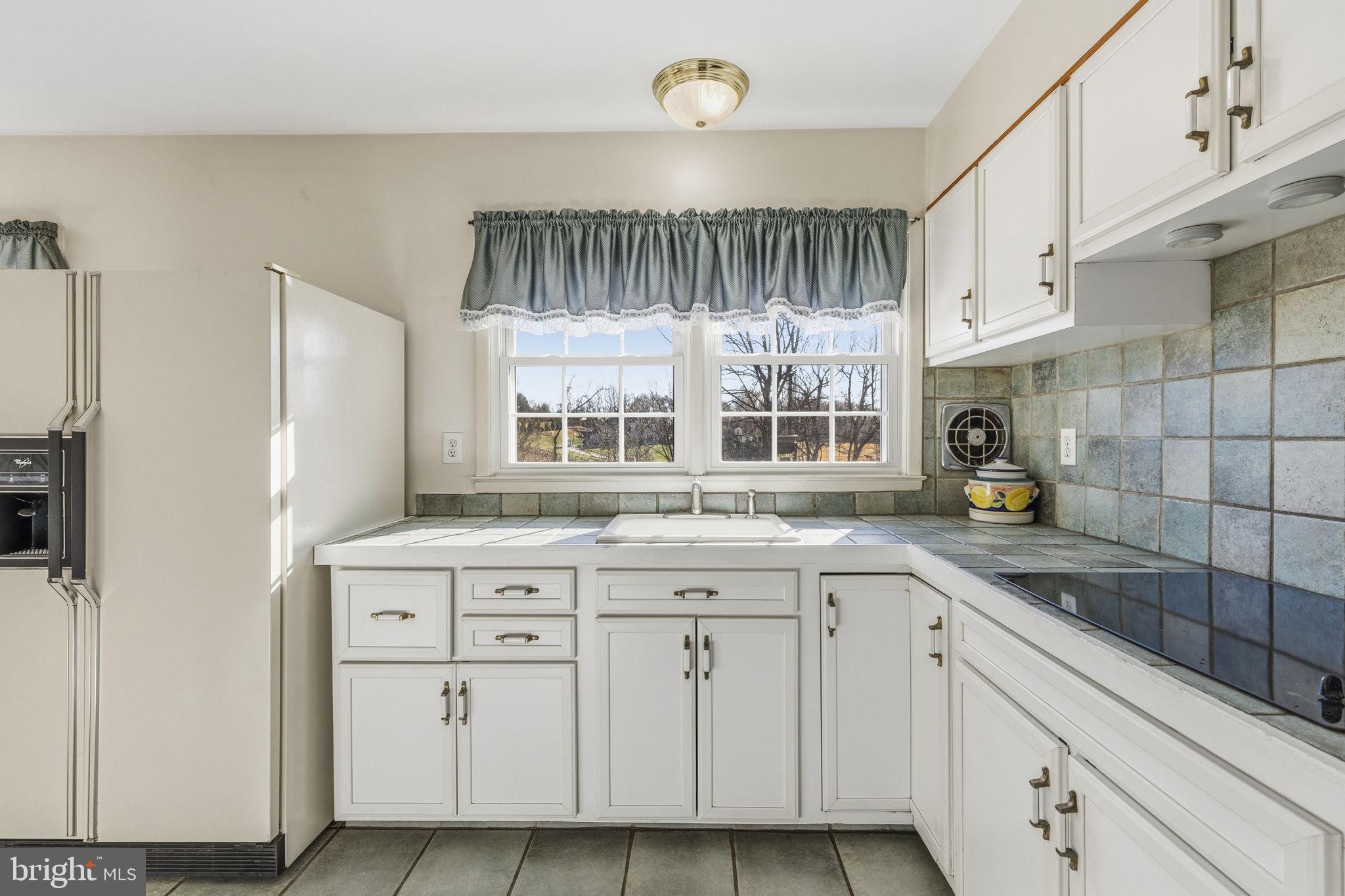 3001 Merrymans Mill Road Phoenix, MD 21131 - Photo 10 of 46 a kitchen with a sink cabinets and window