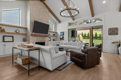 a living room with furniture and a ceiling fan