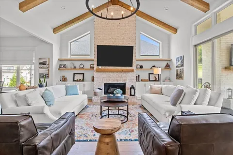 a living room with furniture a flat screen tv and a fireplace