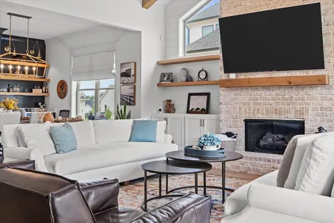 a living room with furniture a rug and white walls