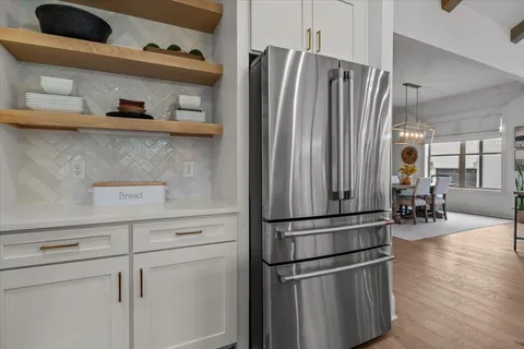 a kitchen with stainless steel appliances a refrigerator sink and cabinets