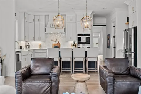 a living room with furniture a table and a large window