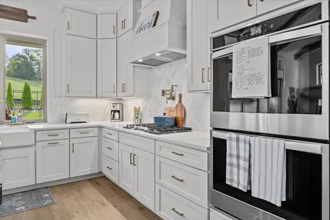 a kitchen with a sink stove and cabinets