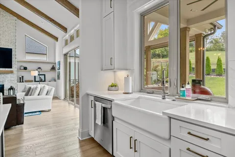 a kitchen with white cabinets and a sink