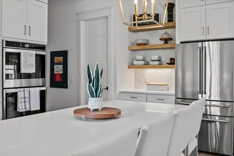 a spacious bathroom with a double vanity sink a mirror and a bathtub