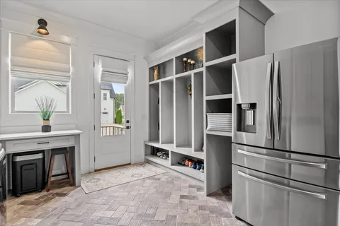 a living room with furniture and a floor to ceiling window