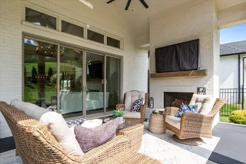 a view of a white house with a big yard and potted plants