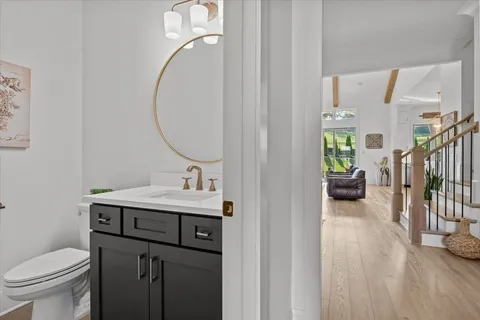 a kitchen with stainless steel appliances kitchen island granite countertop a dining table chairs and white cabinets