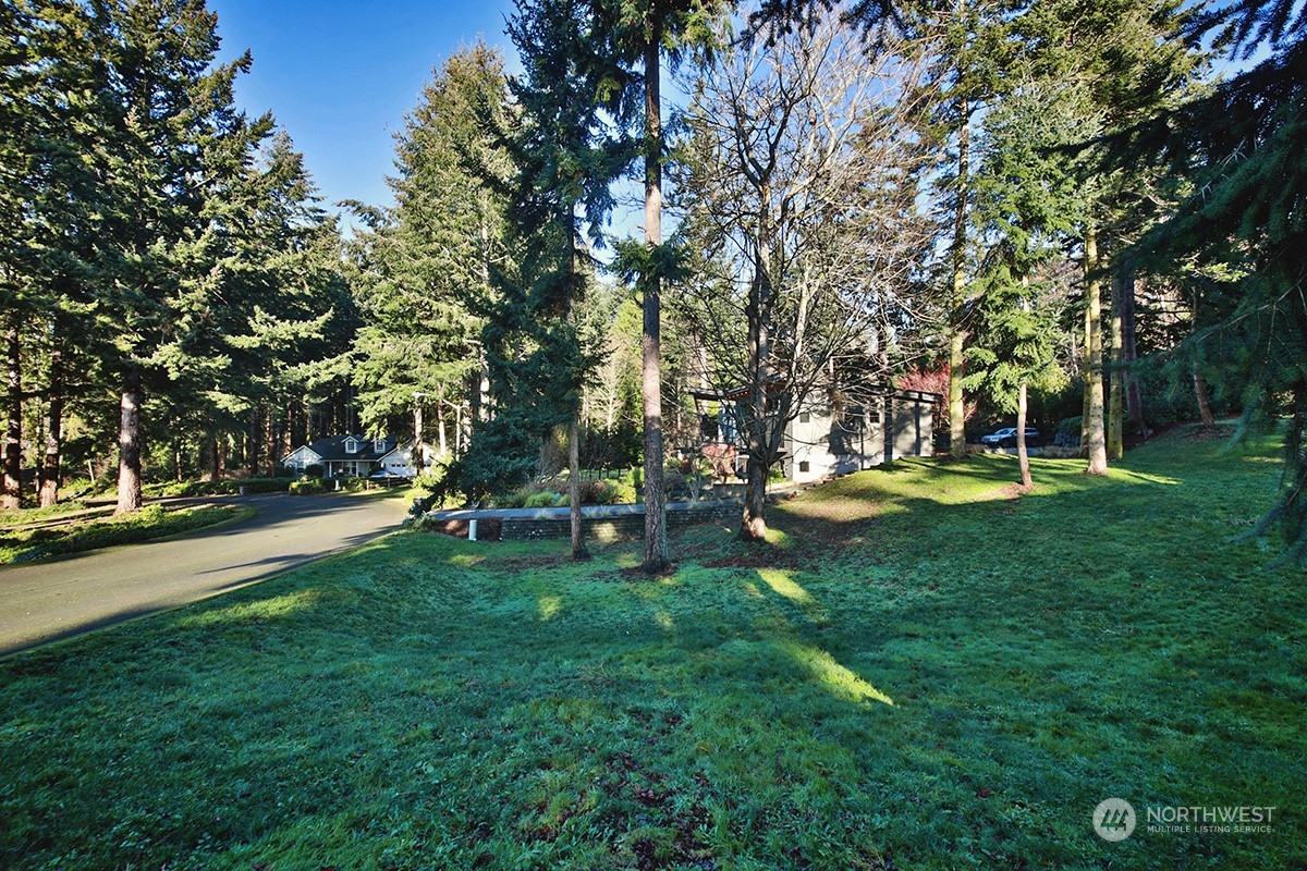 6329 Sahalee Court Clinton, WA 98236 - Photo 16 of 36 a view of a park with swings and a table