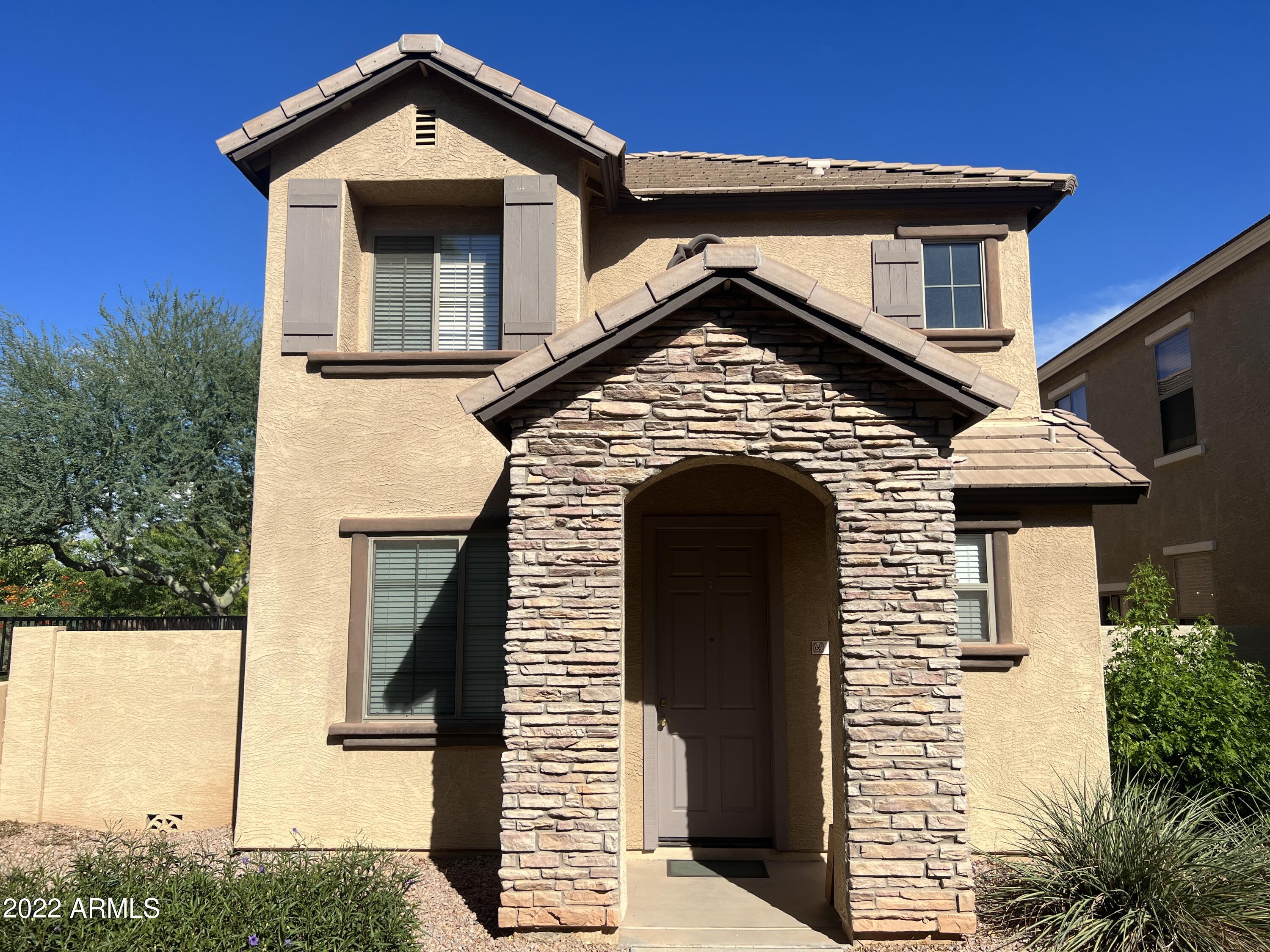 146 East Catclaw Street Gilbert, AZ 85296 - Photo 1 of 20 a front view of a house with a yard