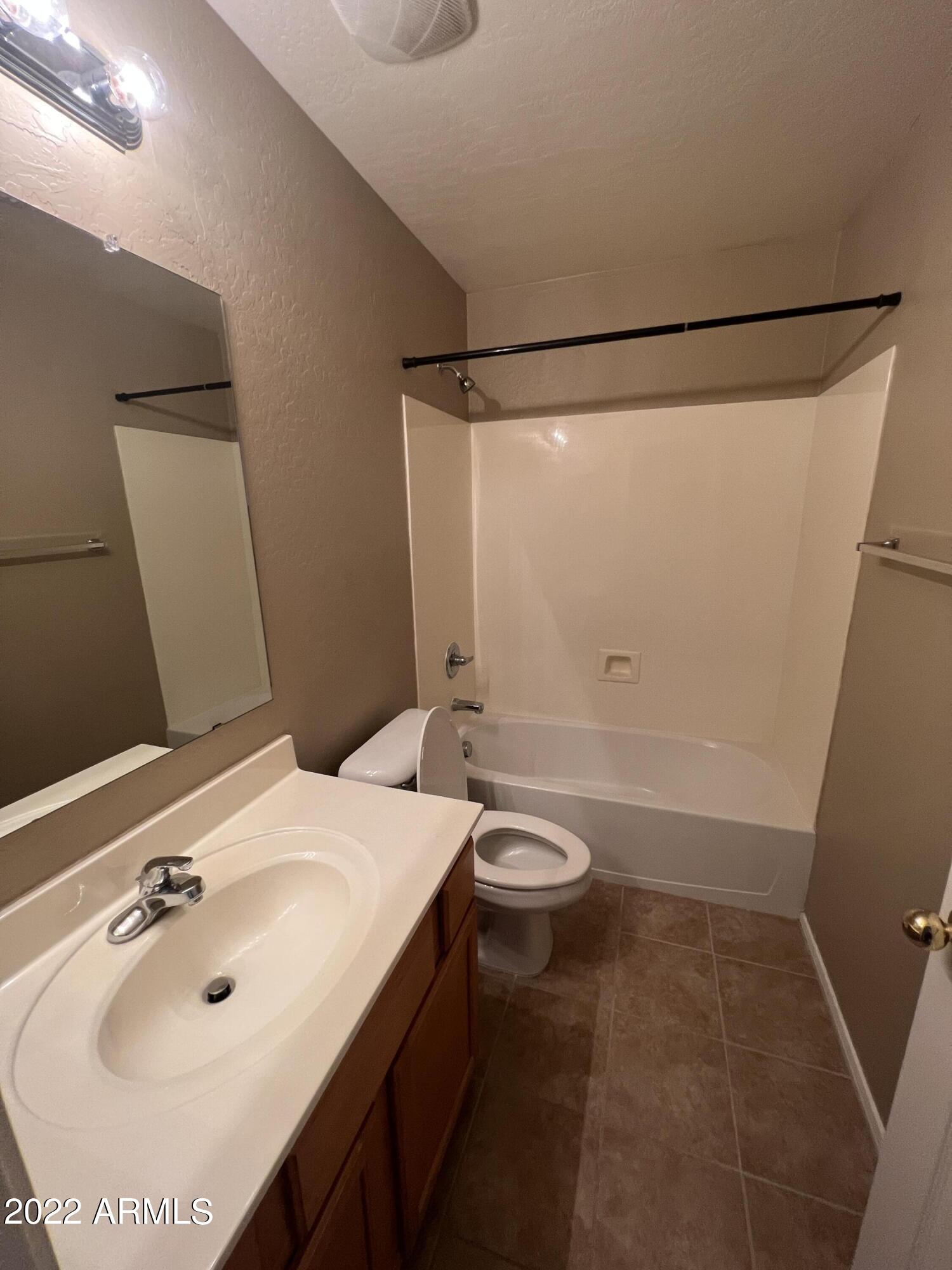 146 East Catclaw Street Gilbert, AZ 85296 - Photo 15 of 20 a bathroom with a sink a toilet and shower