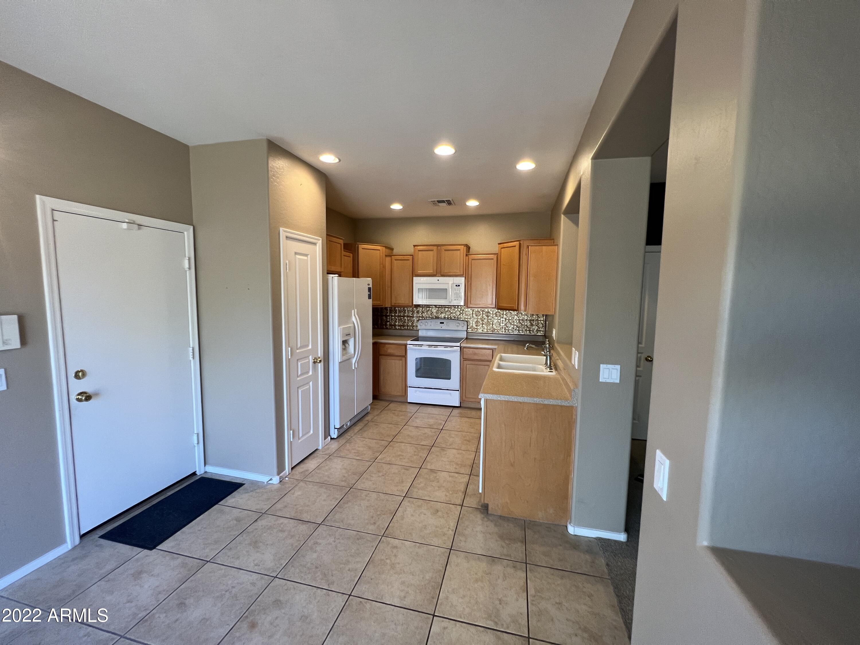 146 East Catclaw Street Gilbert, AZ 85296 - Photo 5 of 20 a view of a kitchen with an empty space and a window