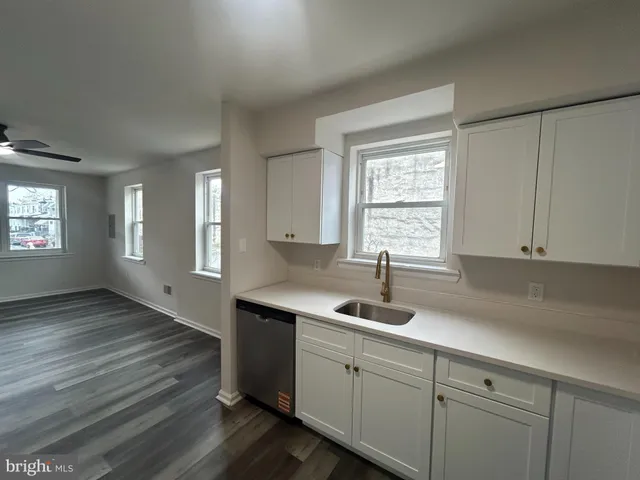 a kitchen with a sink cabinets and window