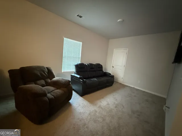 a living room with furniture and a couch