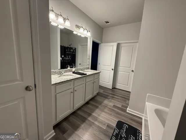 a bathroom with a sink a mirror and a shower