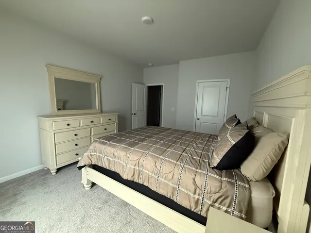 a bed room with a bed and a television