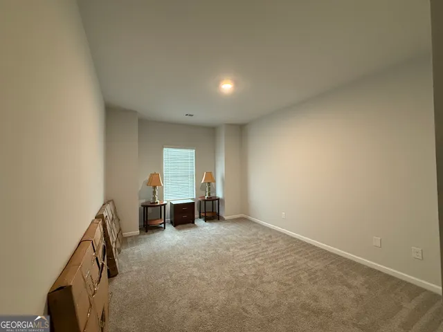 an empty room with furniture and a window