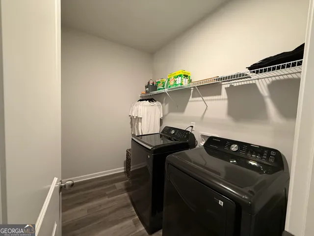 a close view of a stove and a utility room with wooden floor