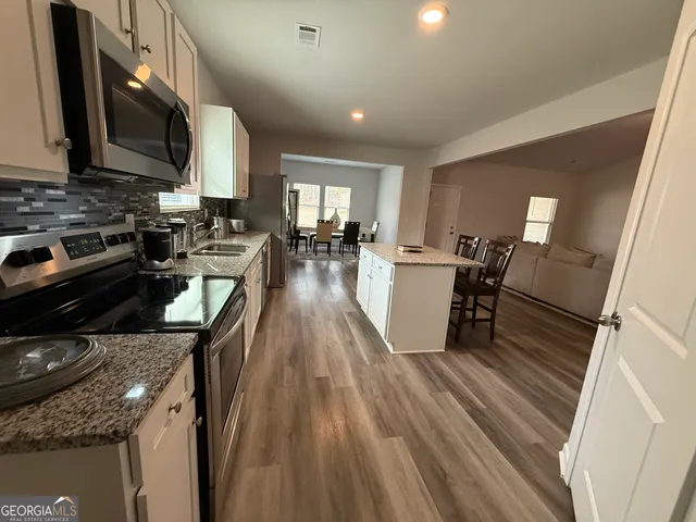 a kitchen with sink stove and cabinets