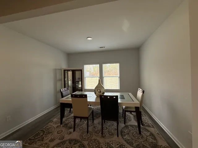 a view of a dining room with furniture and a window