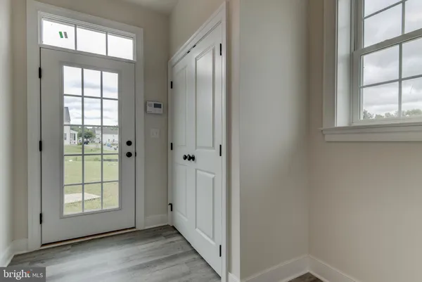 a view of a hallway to rooms and stairs