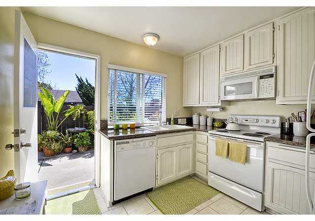 BRIGHT AND SUNNY KITCHEN WITH WINDOW AND BACK DOOR TO YOUR PRIVATE PATIO/YARD.
