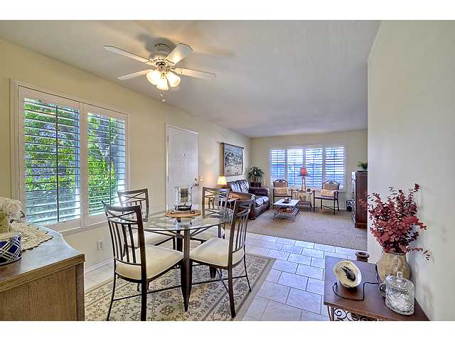 VIEW FROM KITCHEN DOOR ACROSS DINING ROOM INTO THE LIVING ROOM.