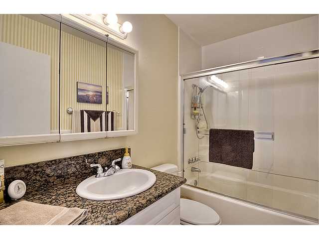 NEAT AND CLEAN BATHROOM WITH GRANITE VANITY TOP AND NEW SHOWER DOOR.