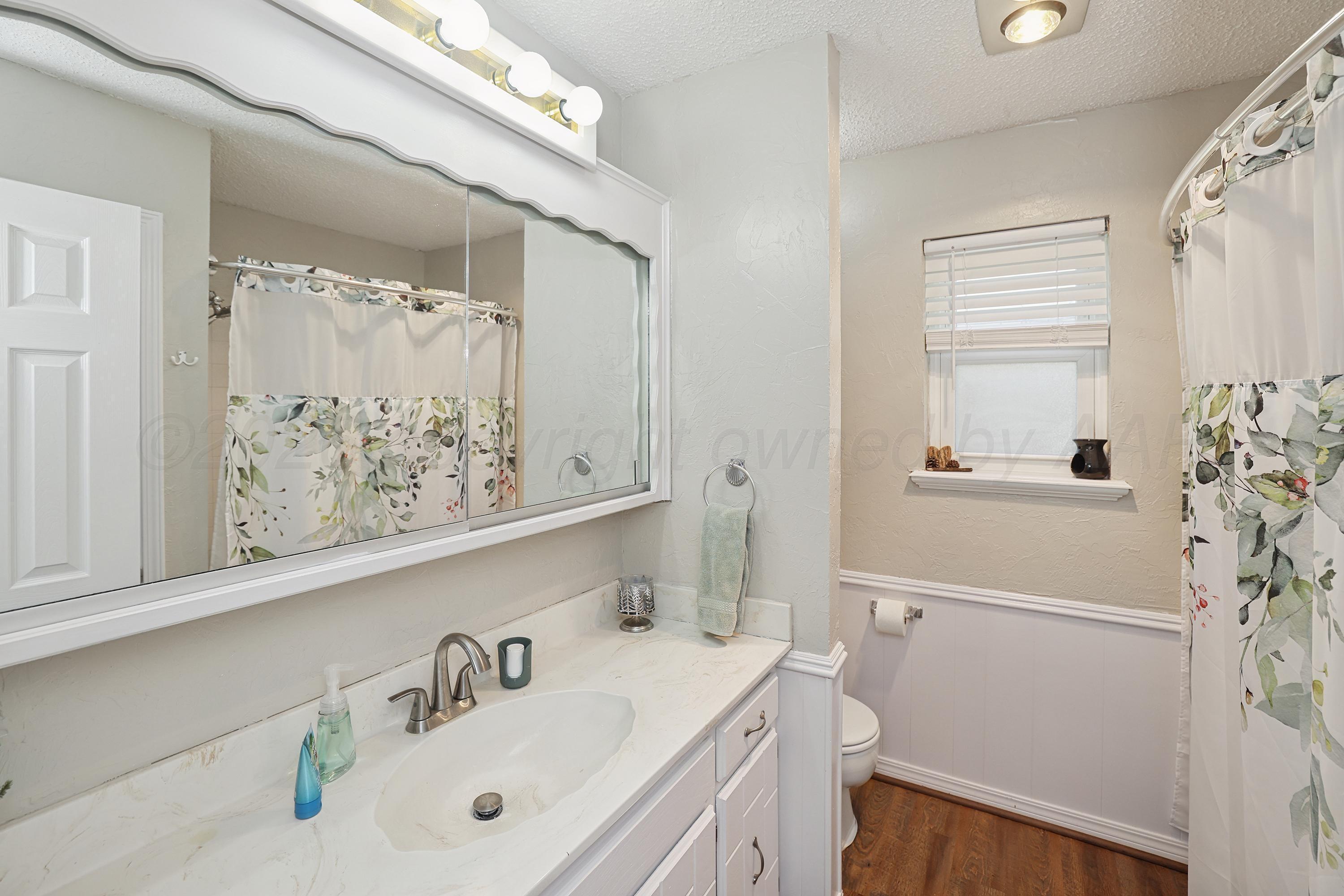 7903 Fenley Drive Amarillo, TX 79121 - Photo 11 of 20 a bathroom with a sink and a mirror