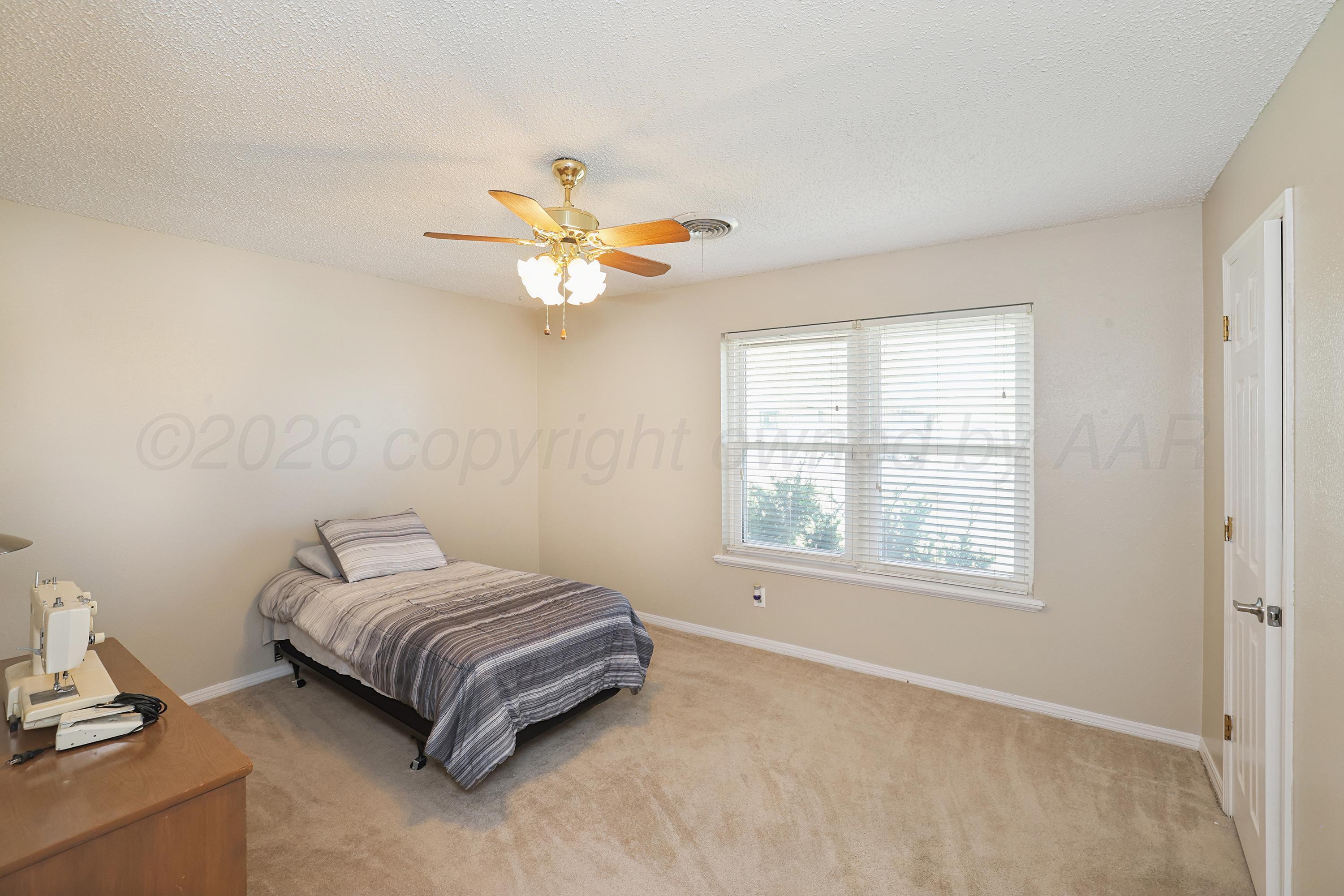 7903 Fenley Drive Amarillo, TX 79121 - Photo 12 of 20 a bedroom with a bed and a window