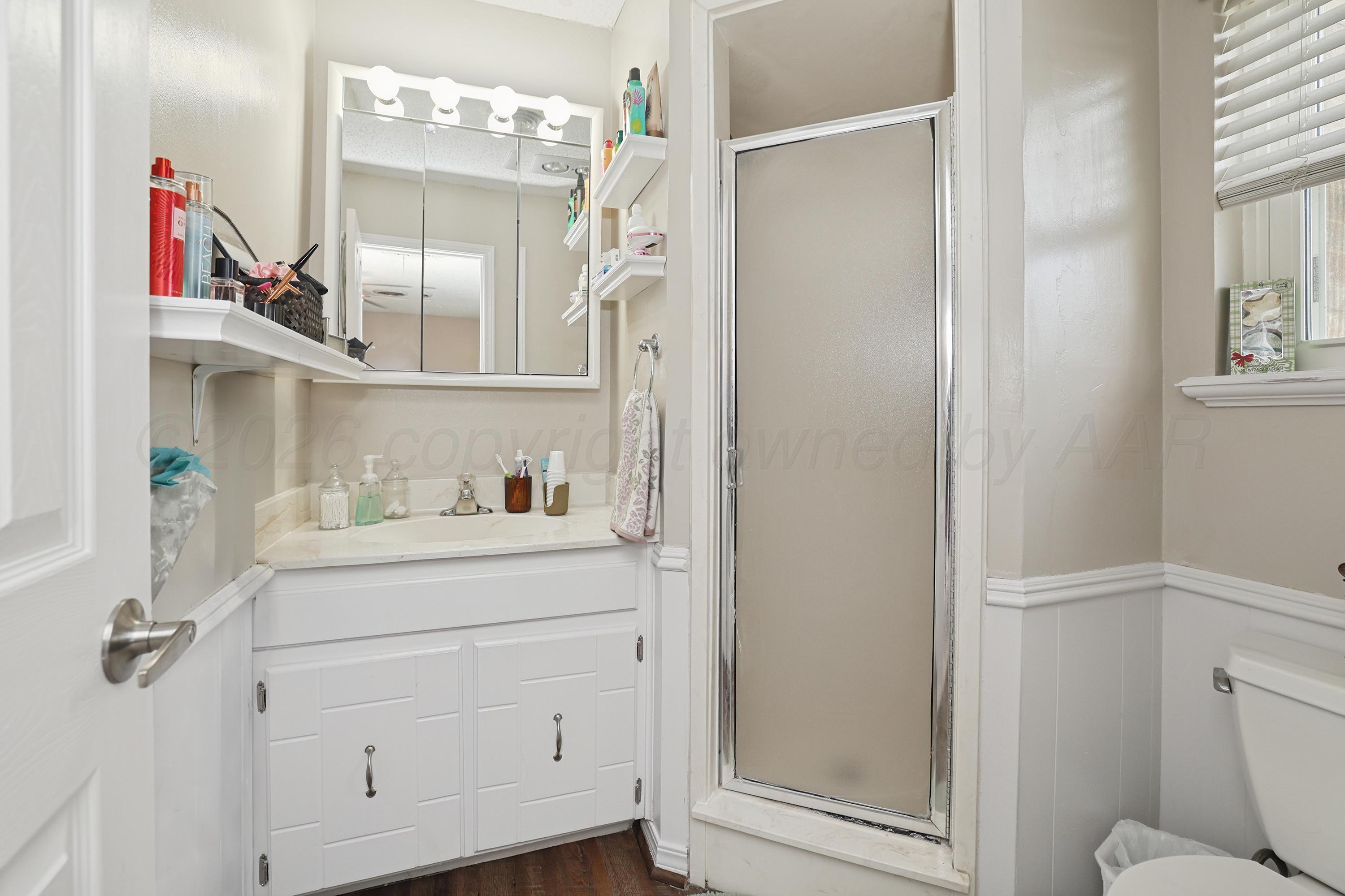 7903 Fenley Drive Amarillo, TX 79121 - Photo 13 of 20 a bathroom with a sink vanity mirror and toilet
