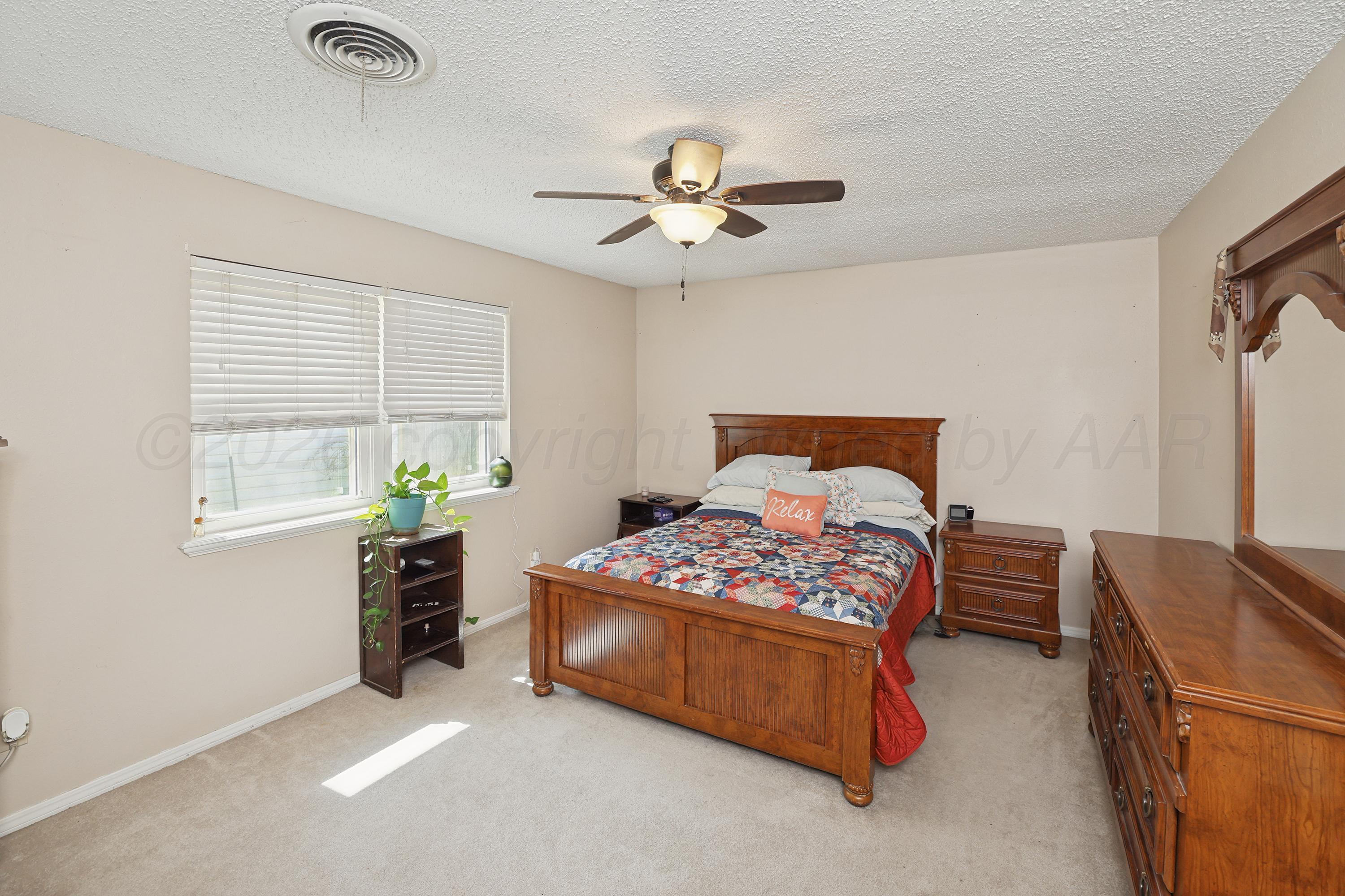 7903 Fenley Drive Amarillo, TX 79121 - Photo 14 of 20 a bedroom with a bed and a window