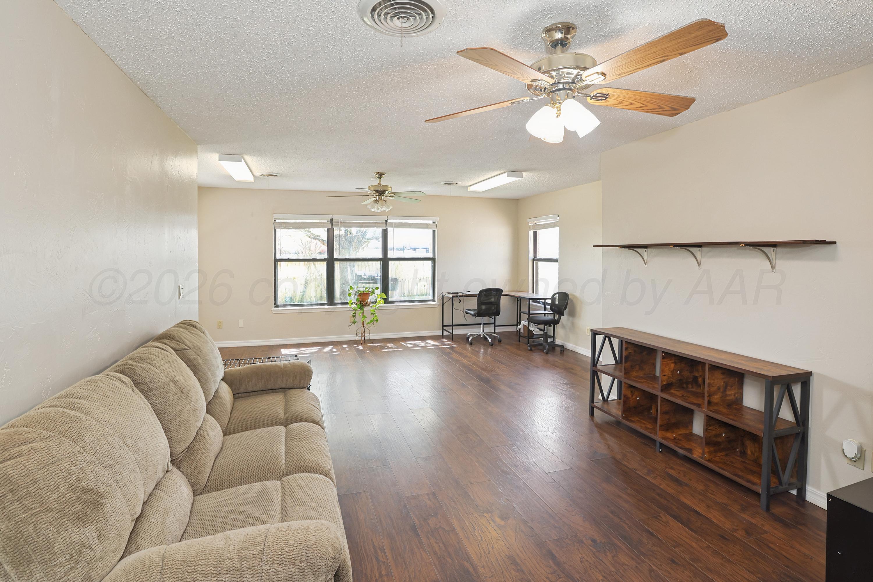7903 Fenley Drive Amarillo, TX 79121 - Photo 15 of 20 a living room with furniture and a large window