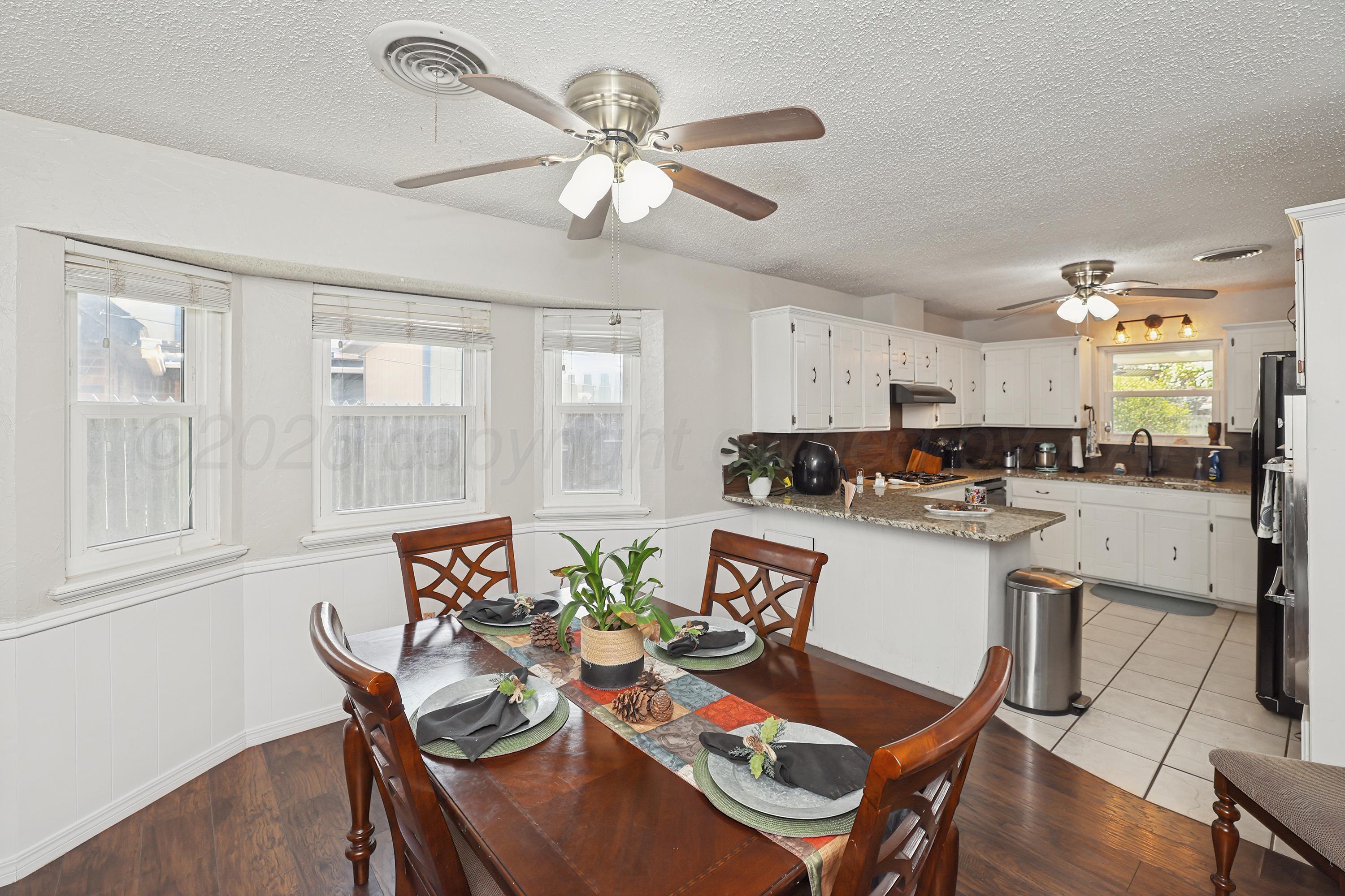 7903 Fenley Drive Amarillo, TX 79121 - Photo 19 of 20 a living room with stainless steel appliances kitchen island granite countertop furniture and a large window