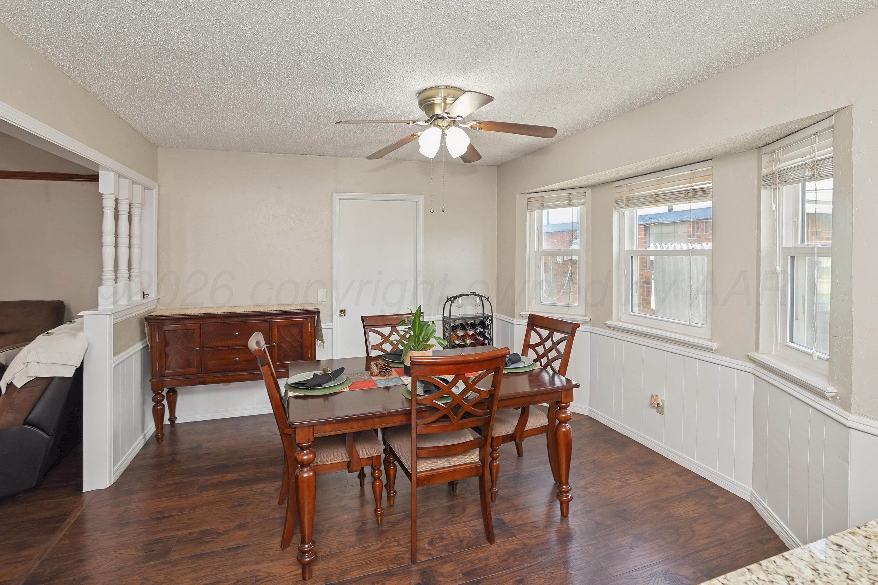 7903 Fenley Drive Amarillo, TX 79121 - Photo 20 of 20 a view of a dining room with furniture a chandelier and wooden floor