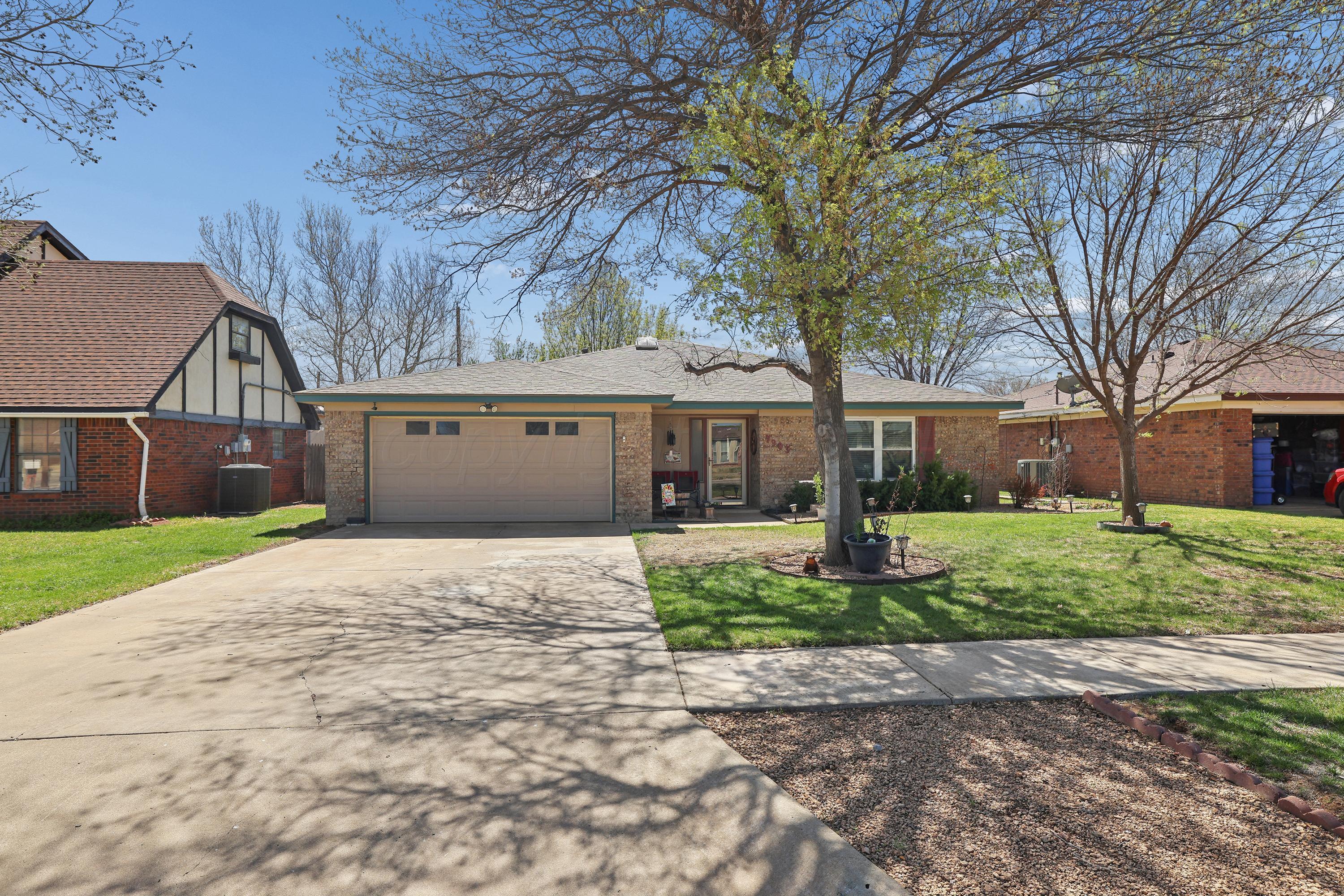 7903 Fenley Drive Amarillo, TX 79121 - Photo 2 of 20 a front view of house with a garden and trees