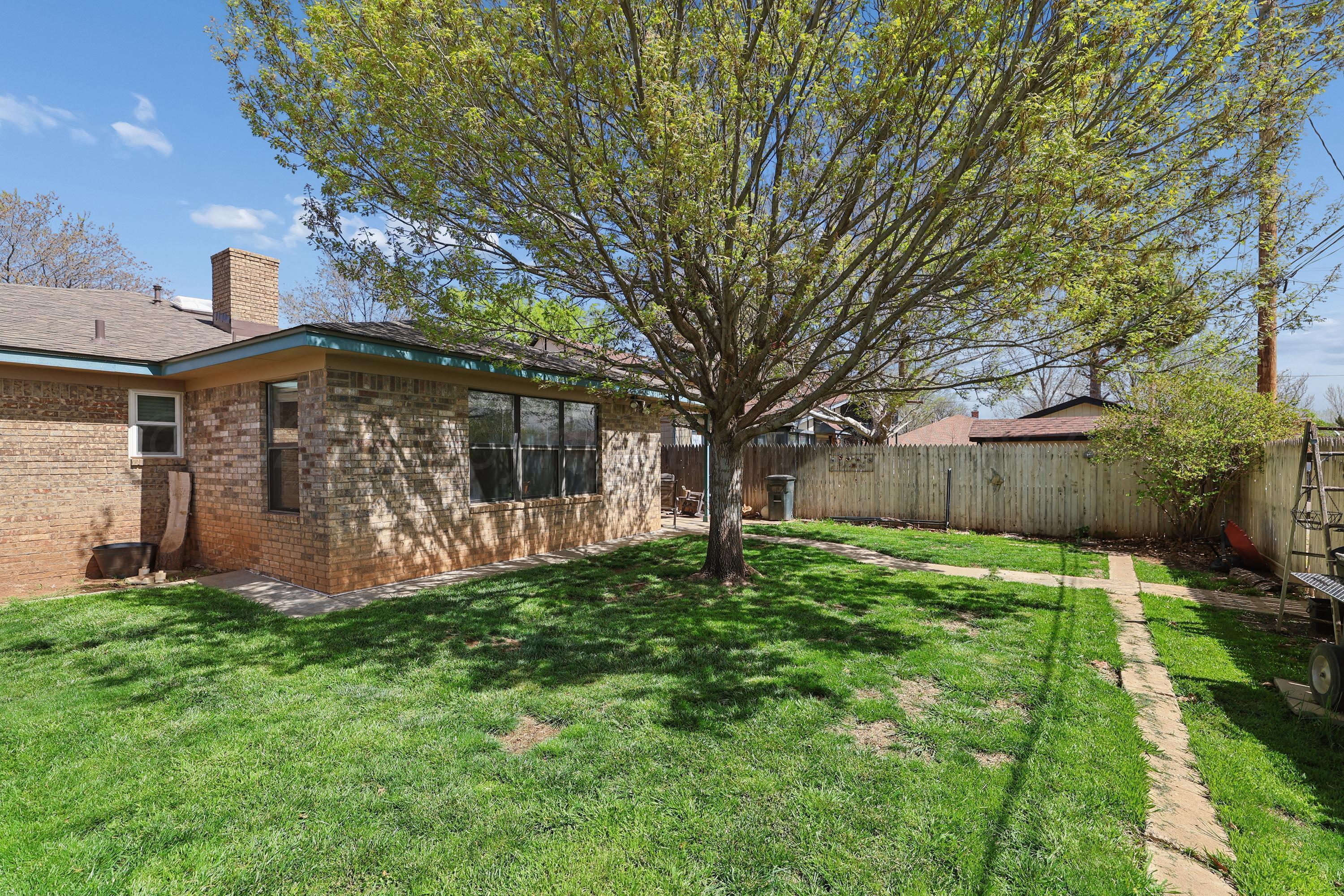 7903 Fenley Drive Amarillo, TX 79121 - Photo 7 of 20 a view of a house with yard and a tree
