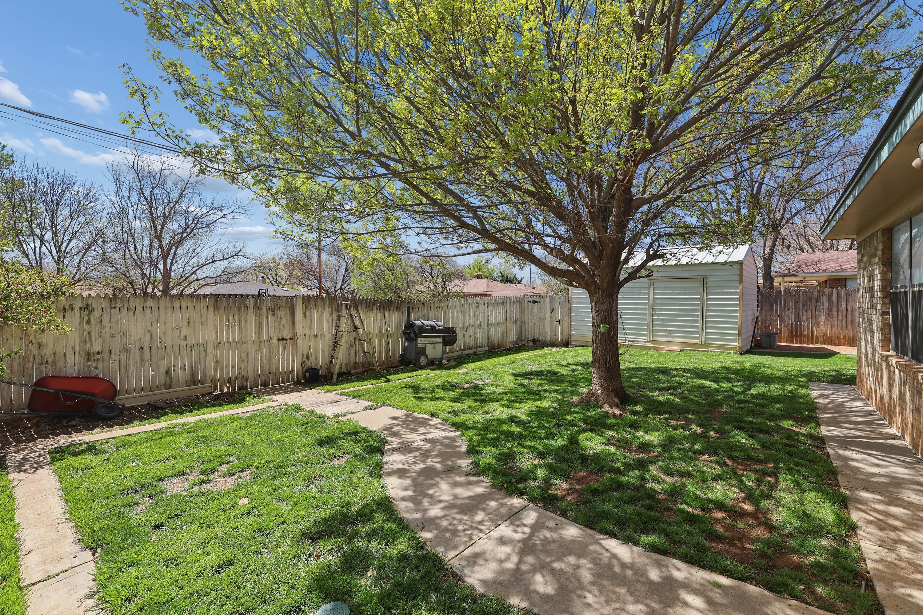 7903 Fenley Drive Amarillo, TX 79121 - Photo 8 of 20 a backyard of a house with lots of green space