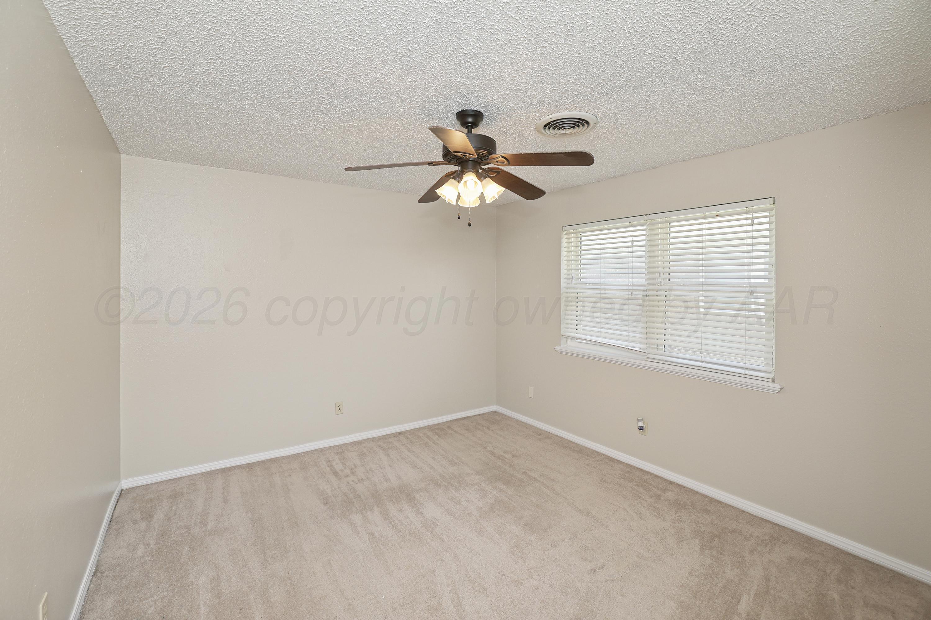 7903 Fenley Drive Amarillo, TX 79121 - Photo 10 of 20 a very nice looking room with a window and a ceiling fan