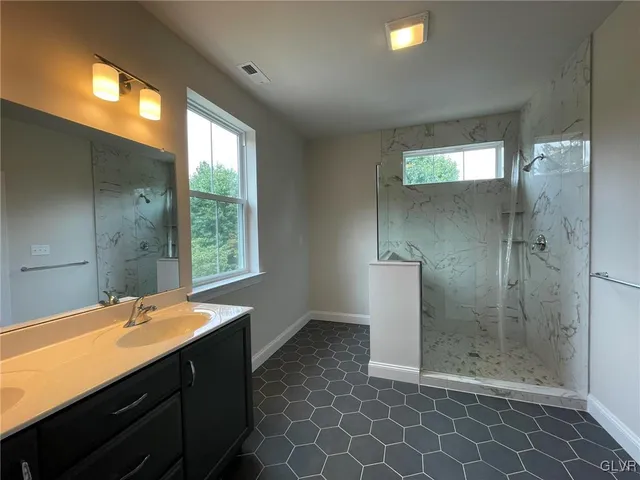 a bathroom with a double vanity sink and a mirror