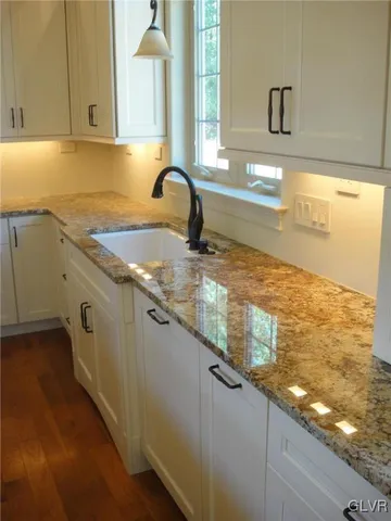 a kitchen with granite countertop a sink and a window