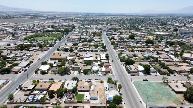 an aerial view of residential houses with city view