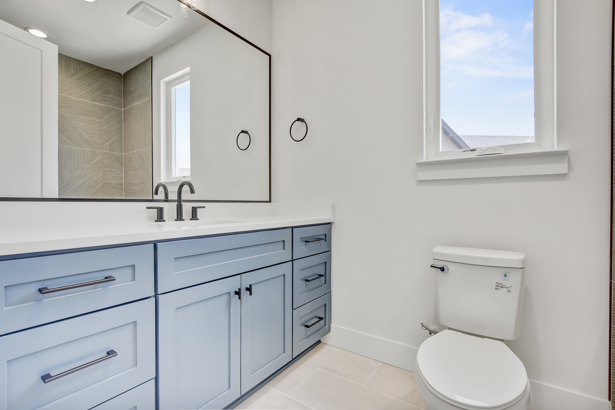 4127 East 12th Street, Unit 8 Austin, TX 78721 - Photo 28 of 32 a bathroom with a toilet a sink a vanity and mirror