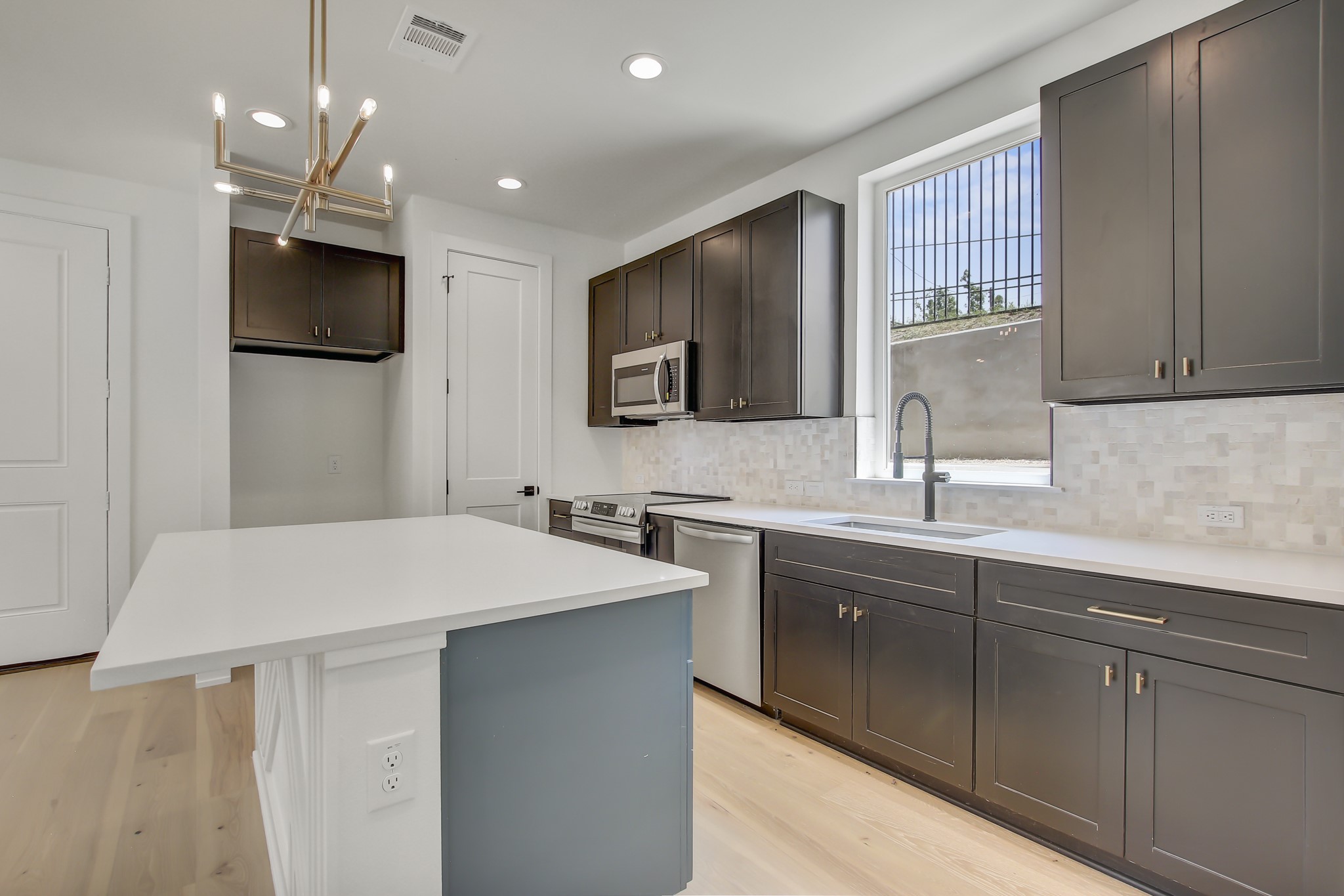 4127 East 12th Street, Unit 8 Austin, TX 78721 - Photo 6 of 32 a kitchen with a sink and a refrigerator